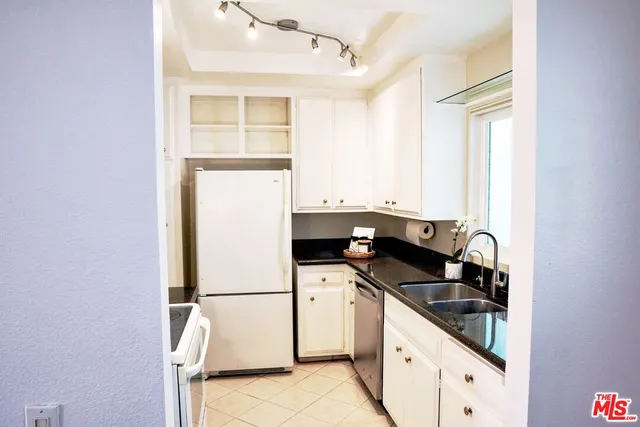 a kitchen with a sink and a stove top oven