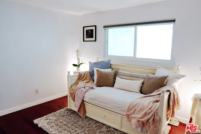 a bed room with a bed and a chair