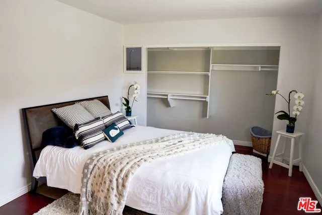 a bedroom with a bed and a chair