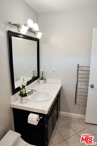 a bathroom with a sink a vanity and a mirror