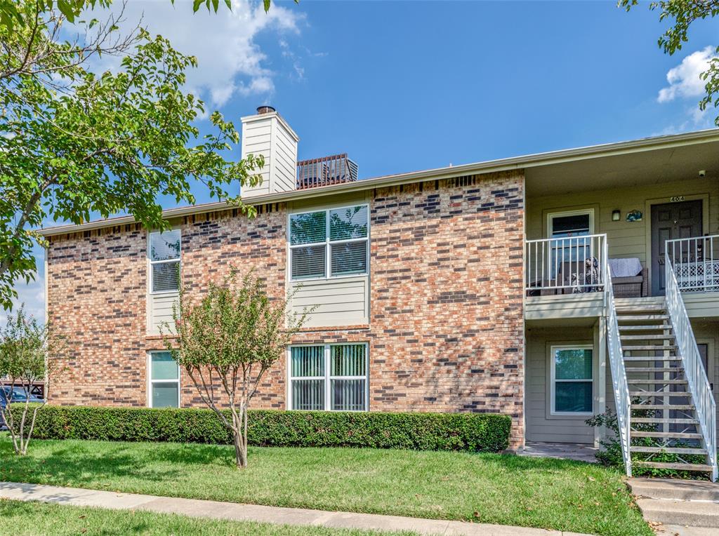 2200 East Trinity Mills Road, Unit 402 Carrollton, TX 75006 - Photo 2 of 12 front view of a house with a yard