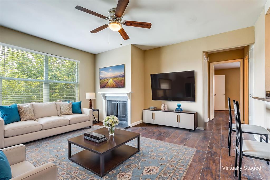 2200 East Trinity Mills Road, Unit 402 Carrollton, TX 75006 - Photo 7 of 12 a living room with furniture and a flat screen tv