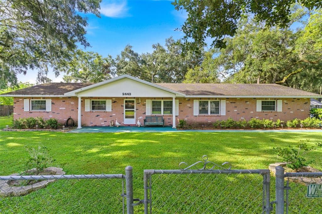 2443 McCranie Place Lakeland, FL 33801 - Photo 1 of 36 a front view of house with yard and green space