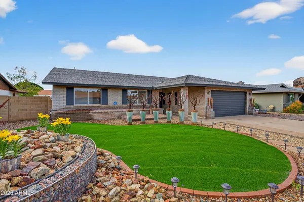 a view of a house with a backyard and porch