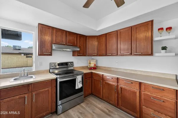 a kitchen with stainless steel appliances granite countertop a sink stove and cabinets