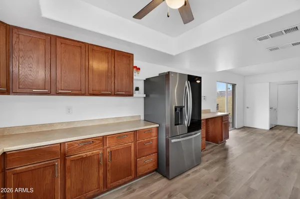 a kitchen with stainless steel appliances granite countertop a refrigerator and a sink