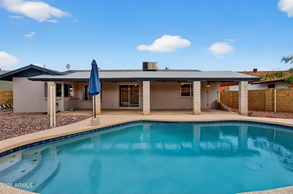 a view of a swimming pool with a patio