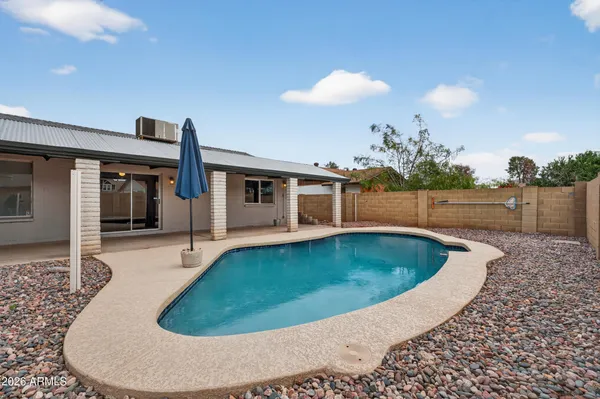 a view of a swimming pool with a yard