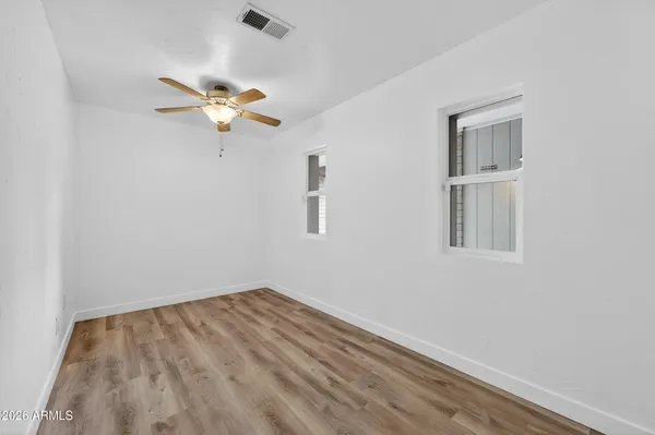 a view of a room with a fan and a window