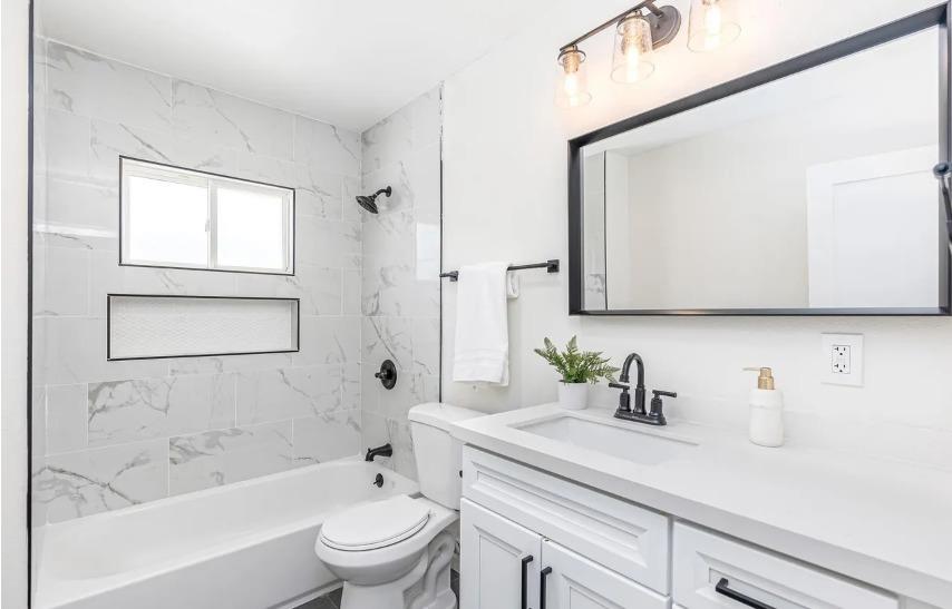 635 Paraiso Avenue Spring Valley, CA 91977 - Photo 17 of 27 a bathroom with a sink a toilet a mirror and shower