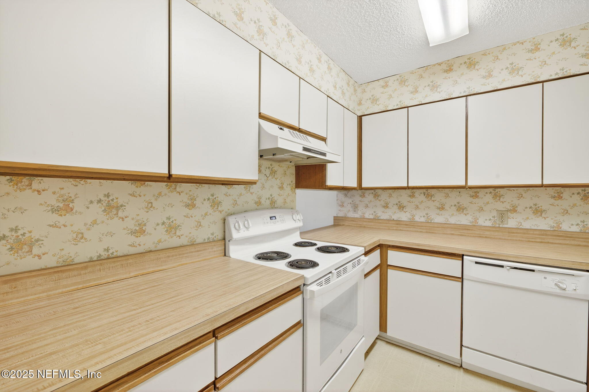 1071 Edgewood Avenue South, Unit 409 Jacksonville, FL 32205 - Photo 12 of 39 a kitchen with white cabinets and white appliances