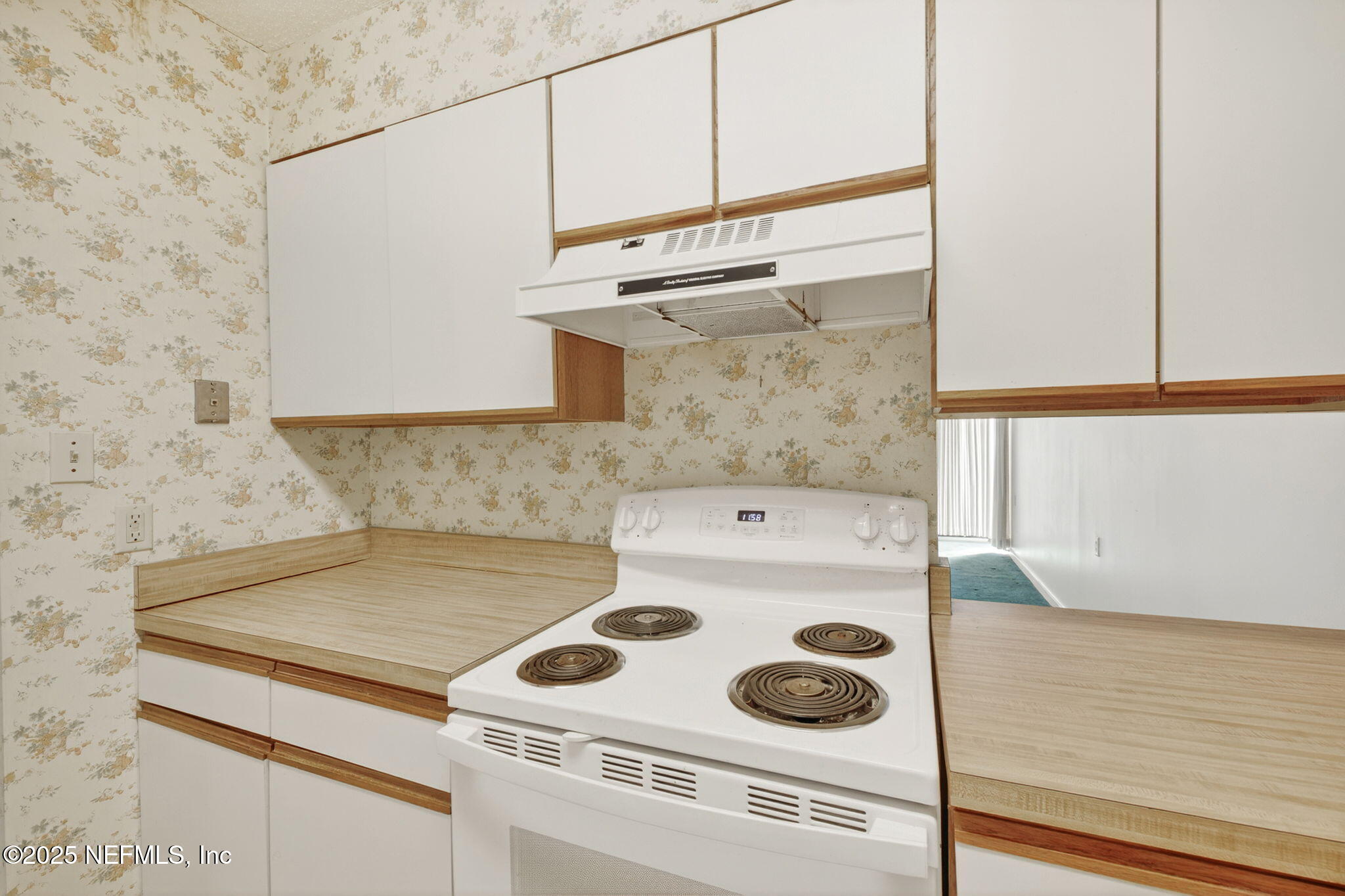1071 Edgewood Avenue South, Unit 409 Jacksonville, FL 32205 - Photo 13 of 39 a kitchen with a stove and a refrigerator
