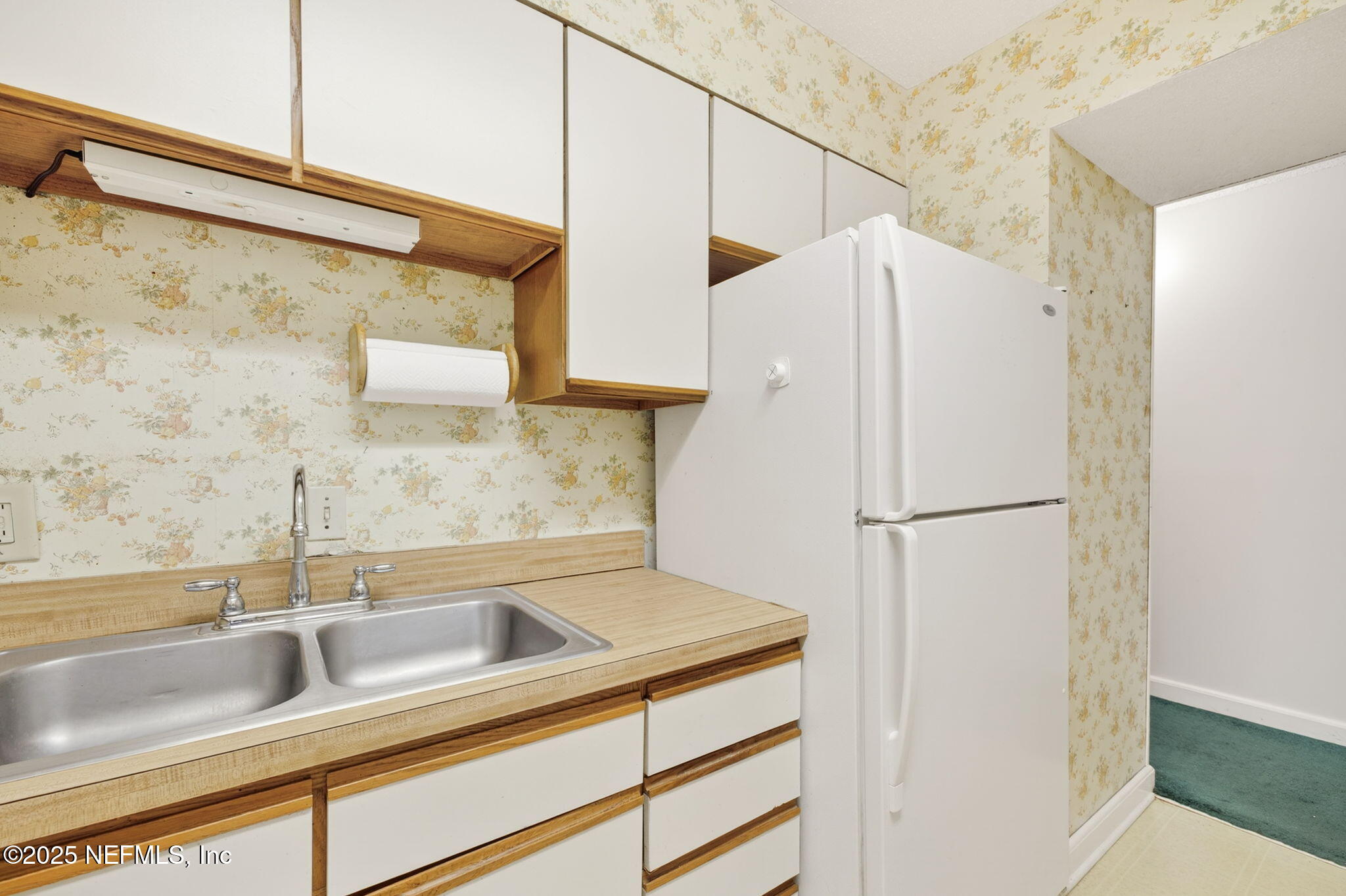 1071 Edgewood Avenue South, Unit 409 Jacksonville, FL 32205 - Photo 15 of 39 a white refrigerator freezer sitting inside of a kitchen