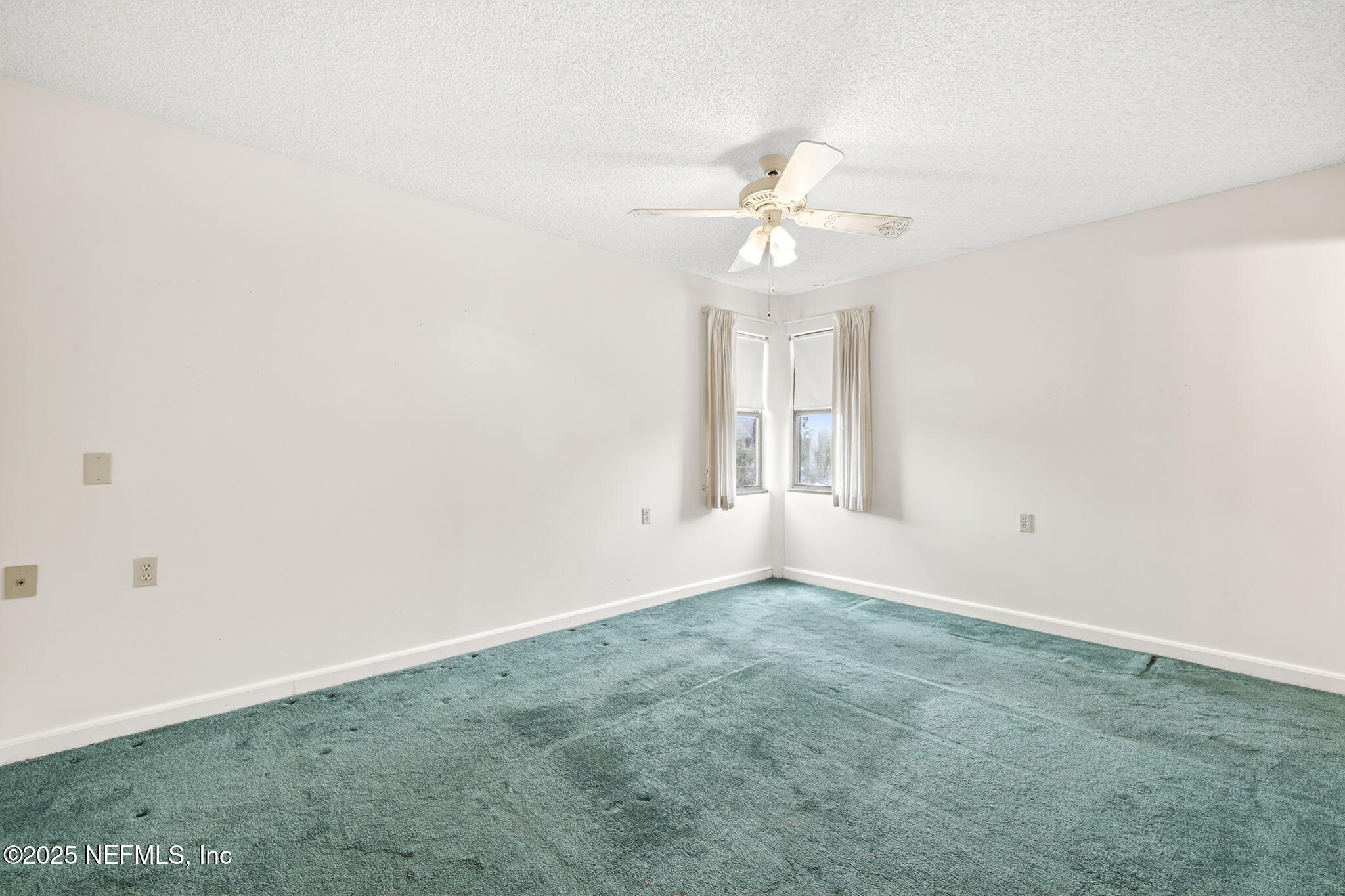 1071 Edgewood Avenue South, Unit 409 Jacksonville, FL 32205 - Photo 17 of 39 an empty room with windows and fan
