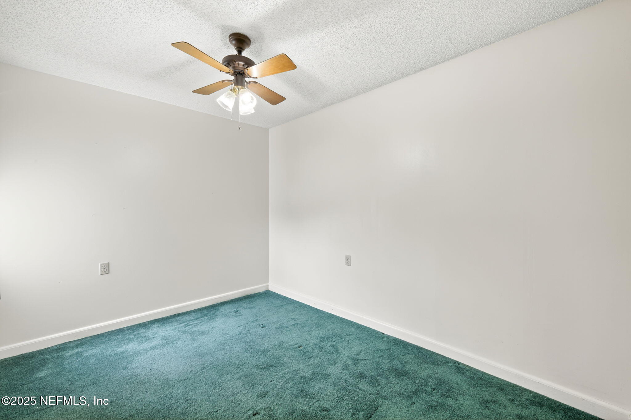 1071 Edgewood Avenue South, Unit 409 Jacksonville, FL 32205 - Photo 23 of 39 an empty room with a window and a ceiling fan