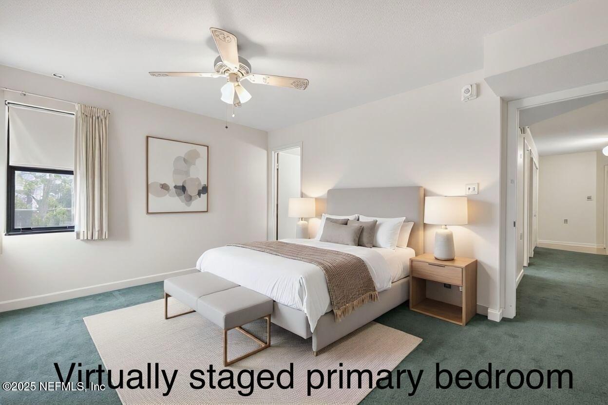 1071 Edgewood Avenue South, Unit 409 Jacksonville, FL 32205 - Photo 3 of 39 a spacious bedroom with a bed and a chandelier