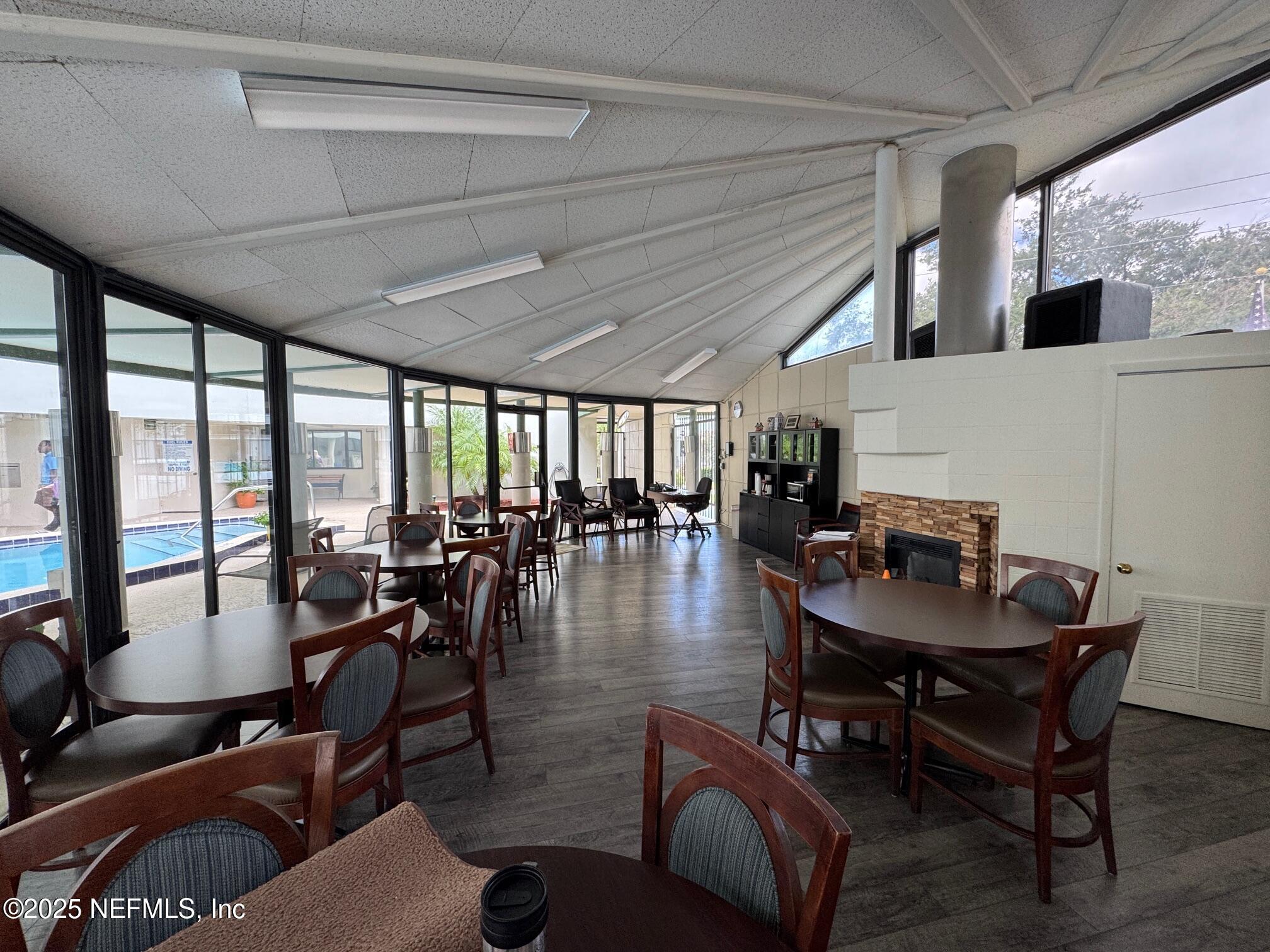 1071 Edgewood Avenue South, Unit 409 Jacksonville, FL 32205 - Photo 34 of 39 a dining room with furniture water view and a floor to ceiling window