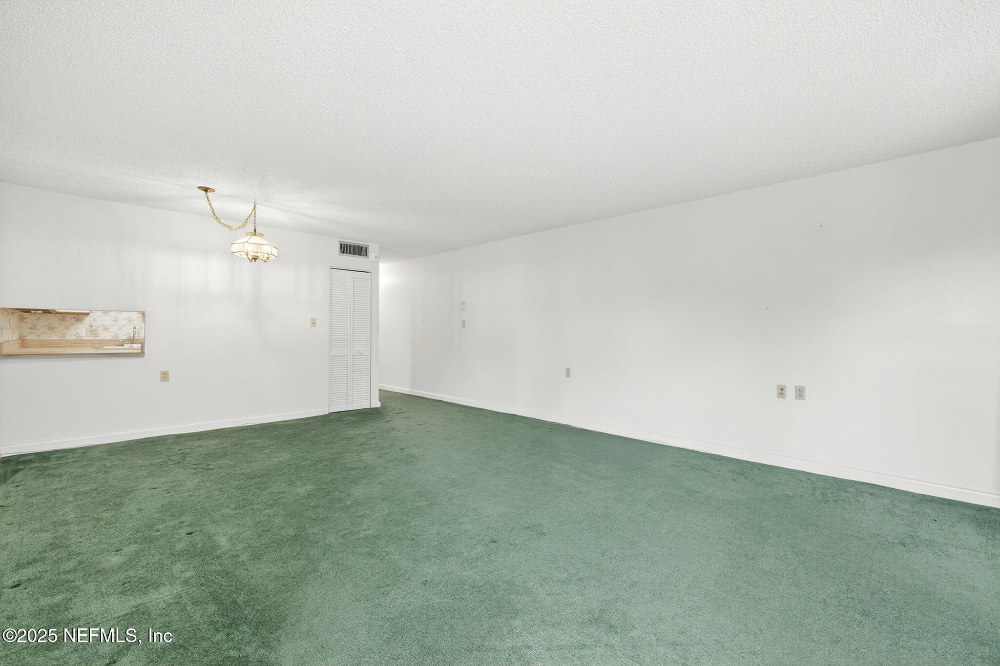 1071 Edgewood Avenue South, Unit 409 Jacksonville, FL 32205 - Photo 7 of 39 an empty room with a ceiling fan and window