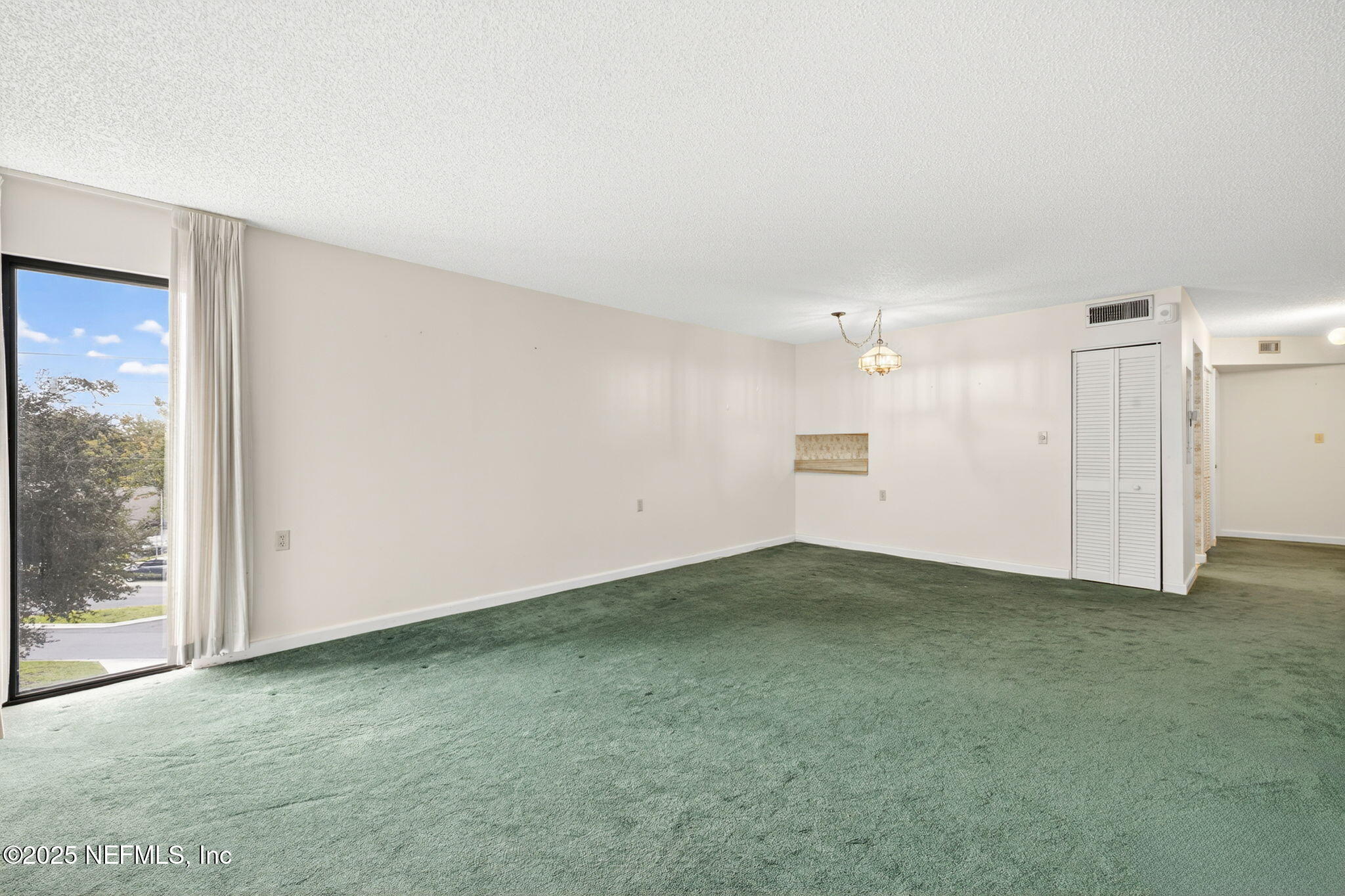 1071 Edgewood Avenue South, Unit 409 Jacksonville, FL 32205 - Photo 9 of 39 a view of an empty room with a window