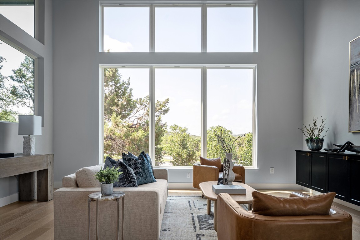 a living room with furniture and a floor to ceiling window