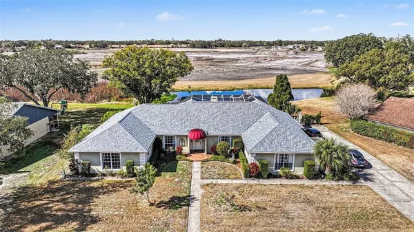 an aerial view of residential houses with outdoor space and ocean