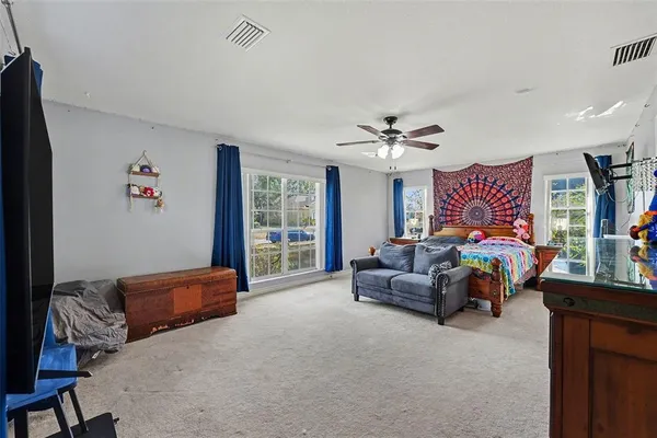 a bedroom with furniture and a chandelier