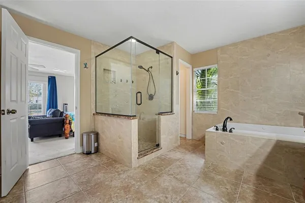 a bathroom with a tub sink and mirror