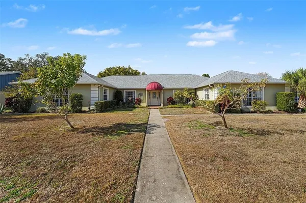 a view of house with yard