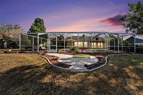 a view of a swimming pool with an outdoor space and seating area