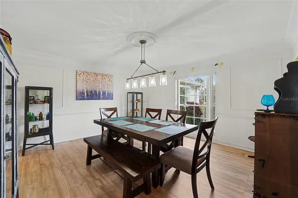 a view of a dining room with furniture wooden floor and chandelier
