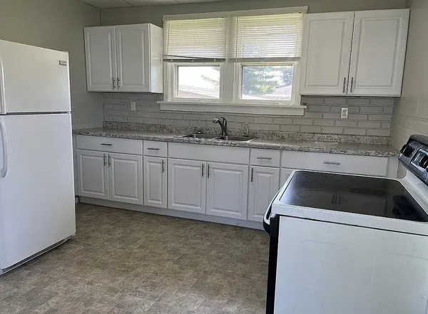 a kitchen with a sink cabinets and window