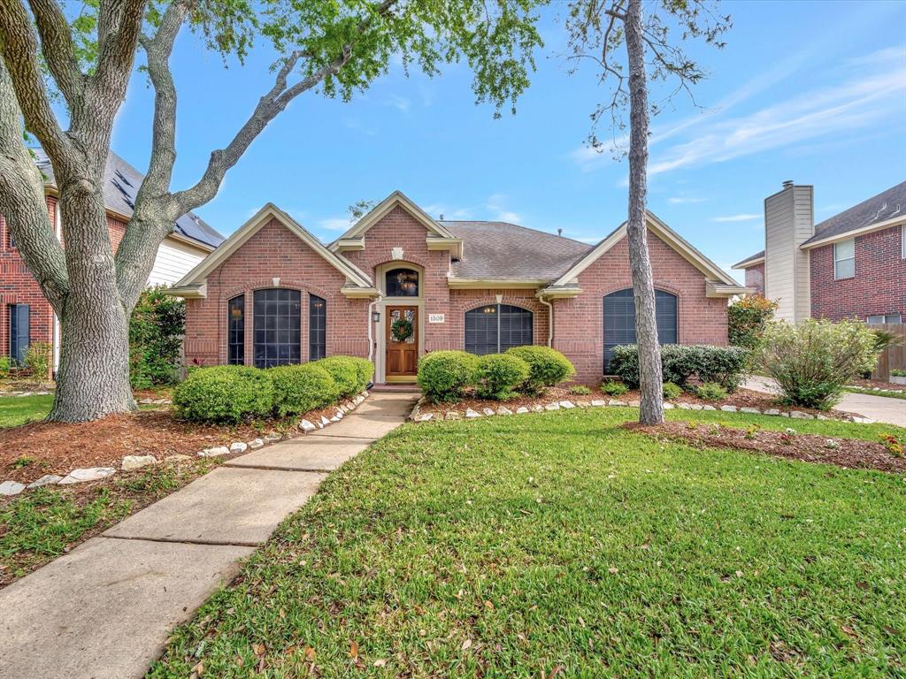 1509 Pine Grove Lane Pearland, TX 77581 - Photo 1 of 50 a front view of a house with garden