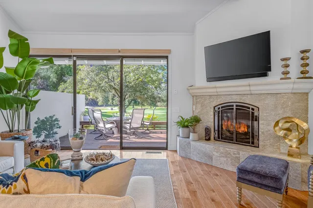 a living room with furniture a fireplace and a flat screen tv