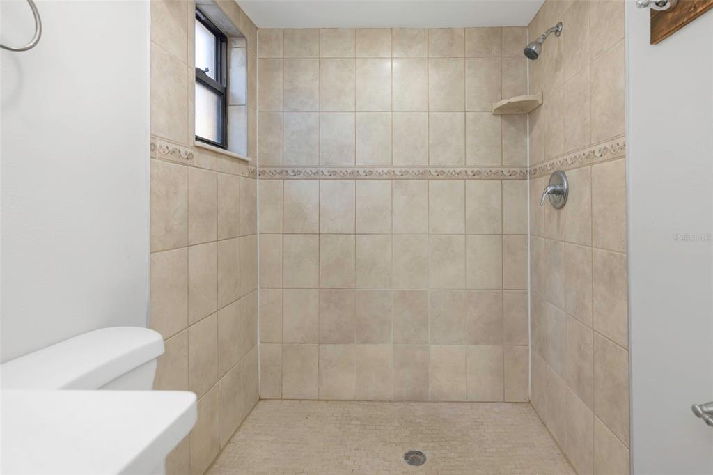 224 Whisper Lake Road Palm Harbor, FL 34683 - Photo 14 of 23 a bathroom with a shower and toilet