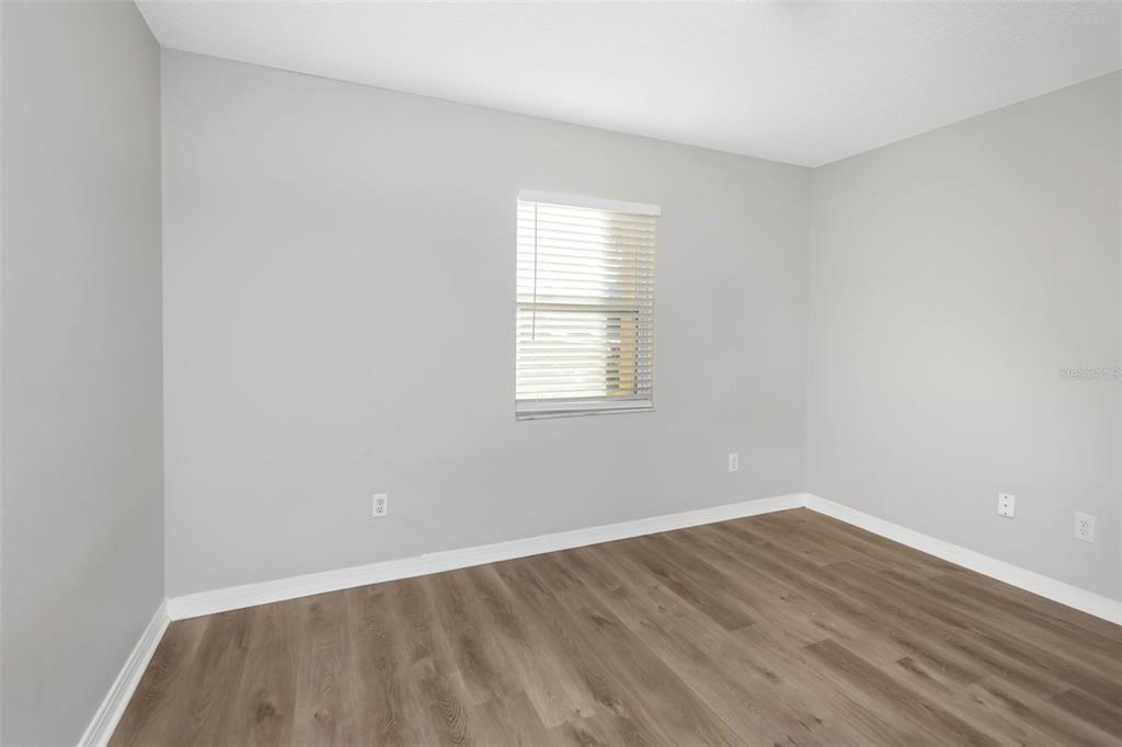 224 Whisper Lake Road Palm Harbor, FL 34683 - Photo 15 of 23 an empty room with wooden floor and windows