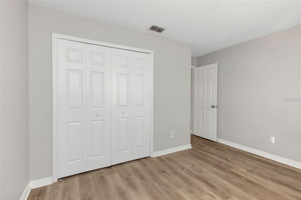 224 Whisper Lake Road Palm Harbor, FL 34683 - Photo 16 of 23 a view of an empty room with wooden floor