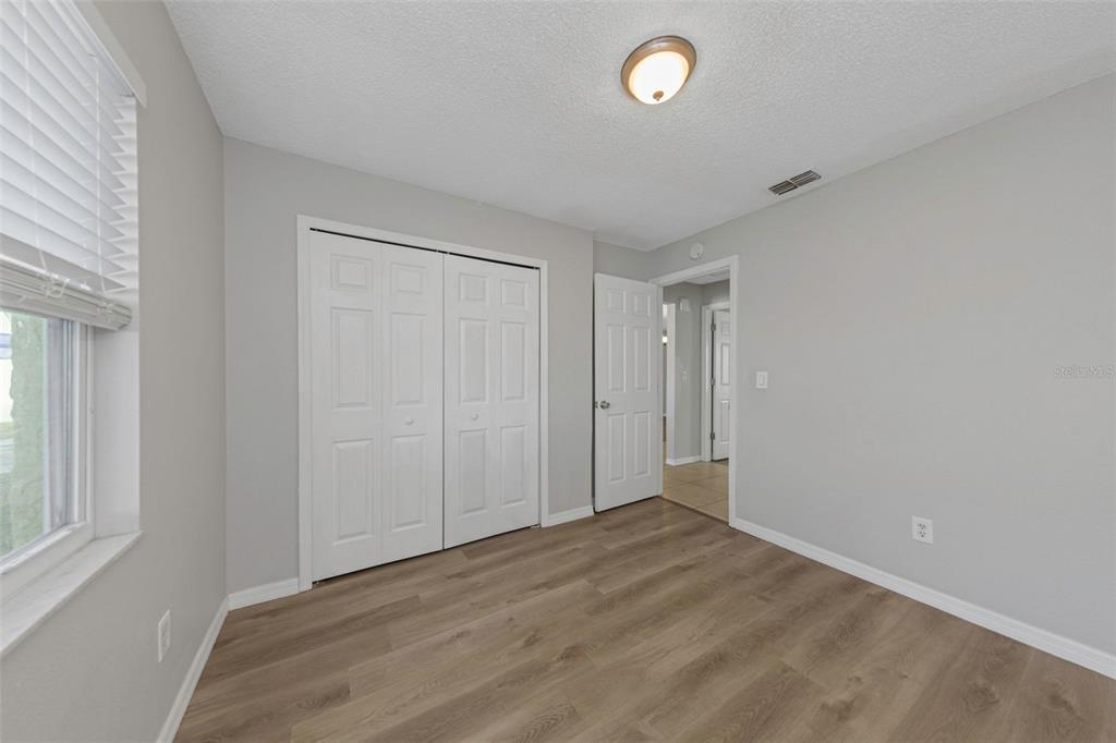 224 Whisper Lake Road Palm Harbor, FL 34683 - Photo 18 of 23 an empty room with wooden floor and windows