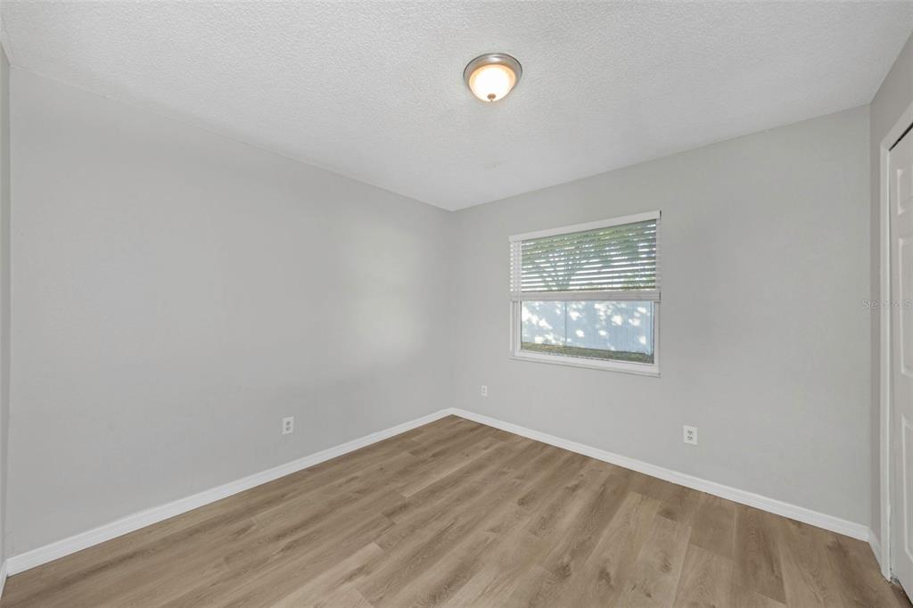 224 Whisper Lake Road Palm Harbor, FL 34683 - Photo 19 of 23 an empty room with wooden floor and windows
