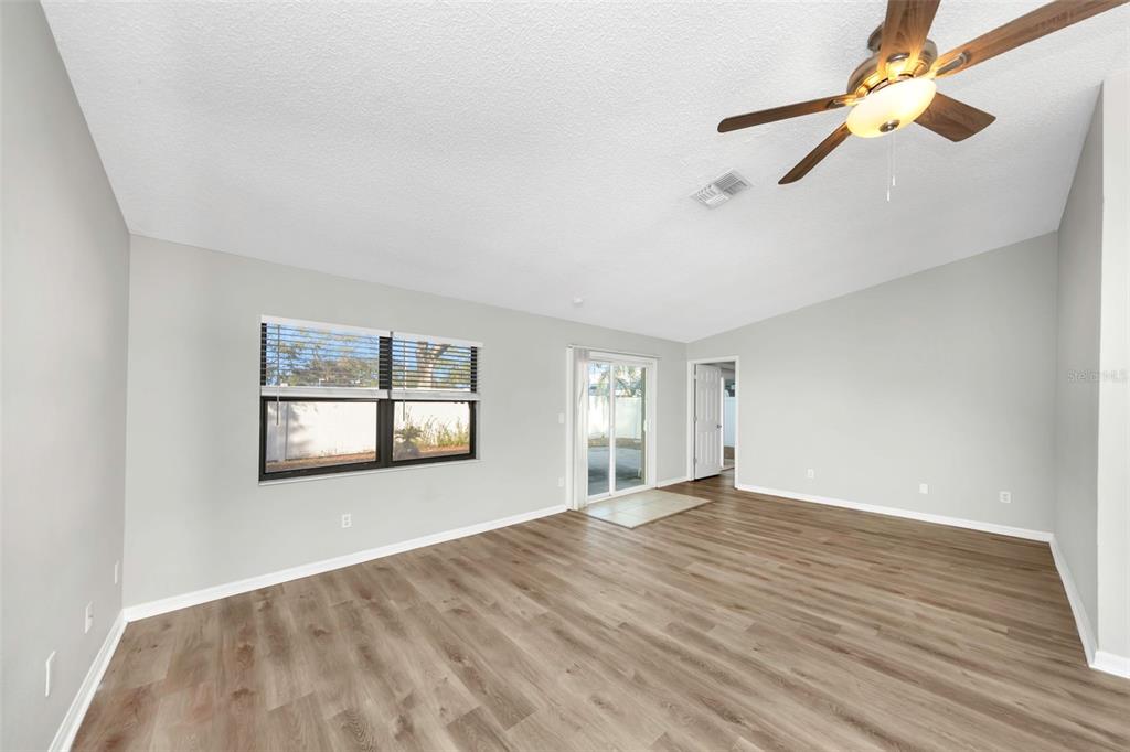 224 Whisper Lake Road Palm Harbor, FL 34683 - Photo 5 of 23 a view of empty room with wooden floor and fan