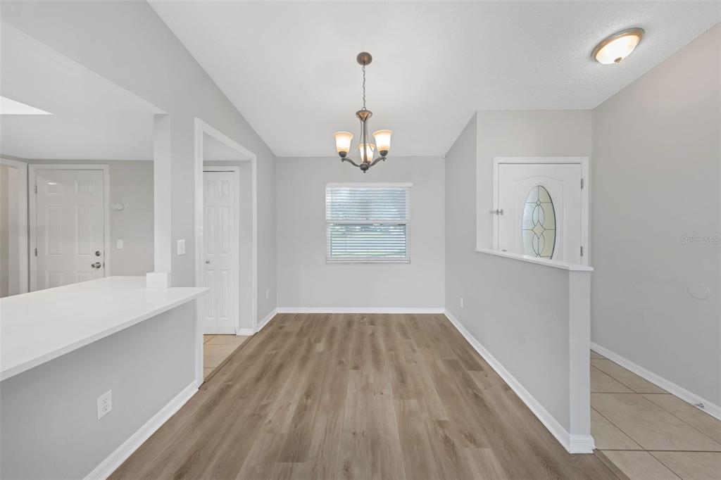 224 Whisper Lake Road Palm Harbor, FL 34683 - Photo 7 of 23 wooden floor in an empty room with a window