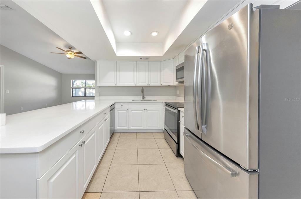 224 Whisper Lake Road Palm Harbor, FL 34683 - Photo 9 of 23 a kitchen with stainless steel appliances a refrigerator sink and cabinets