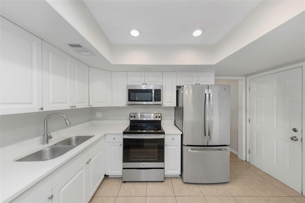 224 Whisper Lake Road Palm Harbor, FL 34683 - Photo 10 of 23 a kitchen with appliances a sink and cabinets