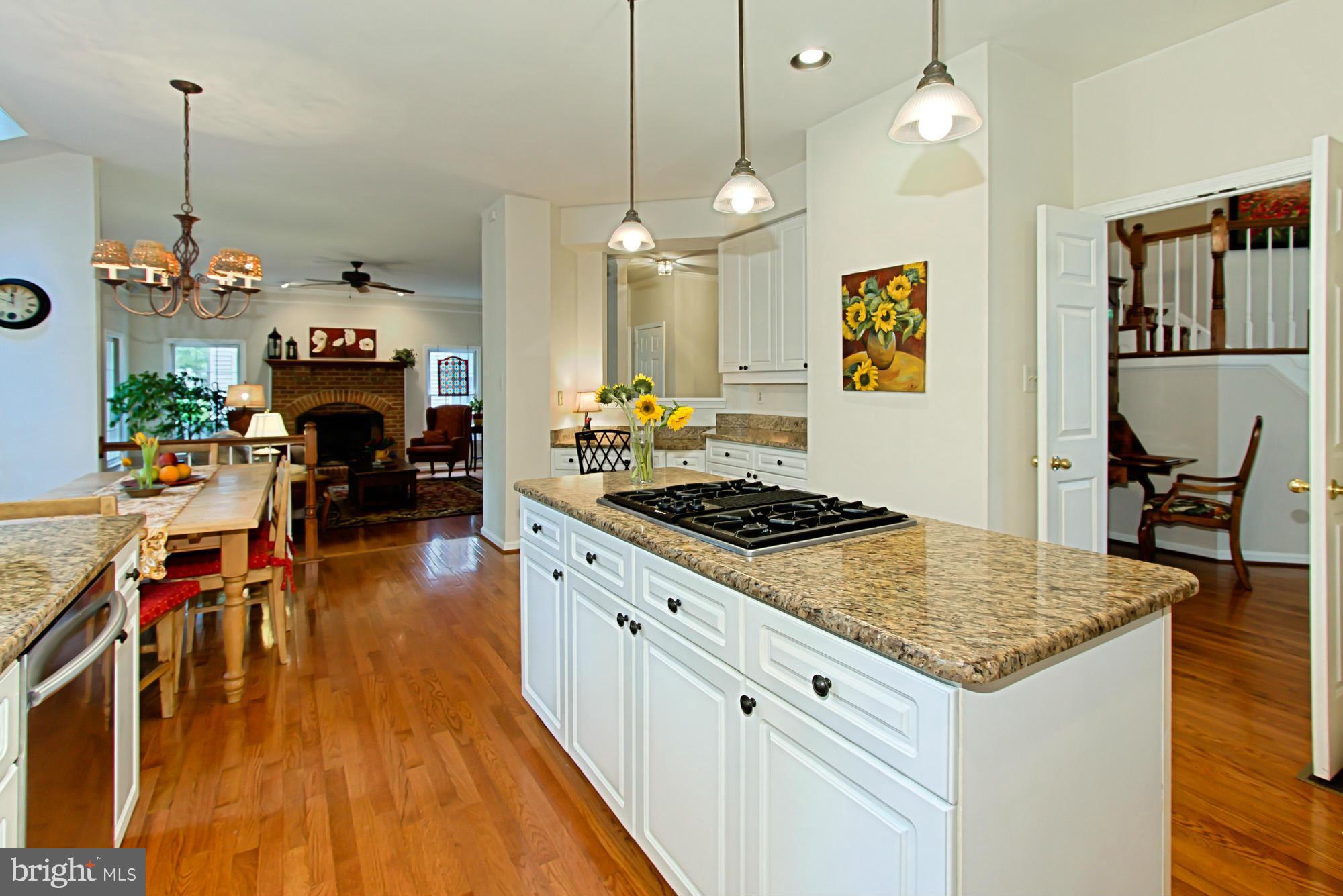 8127 Ridge Creek Way Springfield, VA 22153 - Photo 11 of 30 a kitchen with stove and wooden floor