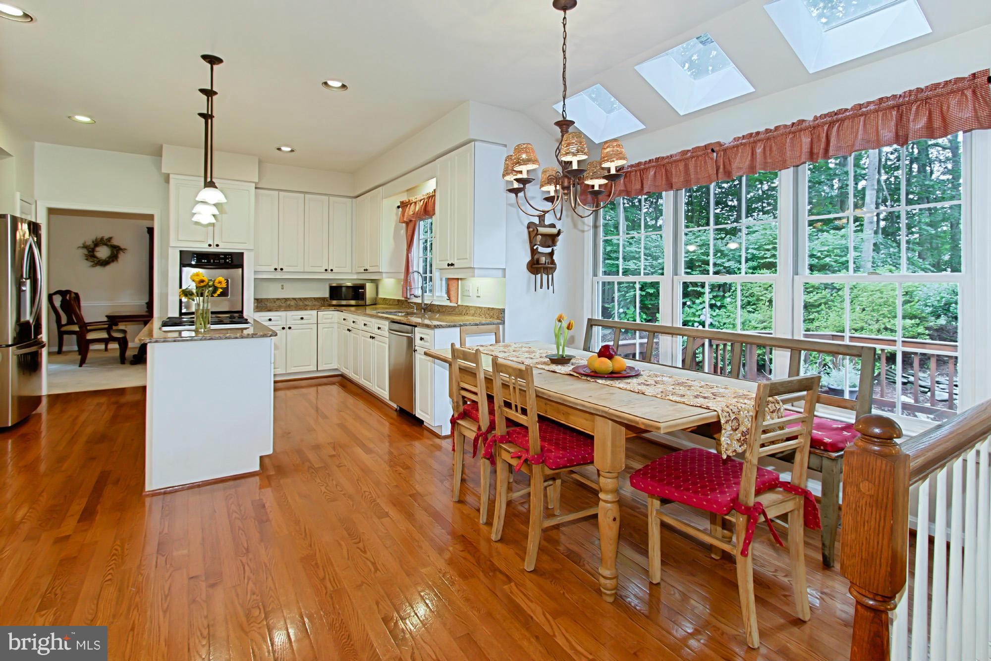 8127 Ridge Creek Way Springfield, VA 22153 - Photo 14 of 30 a view of a dining room with furniture window and wooden floor