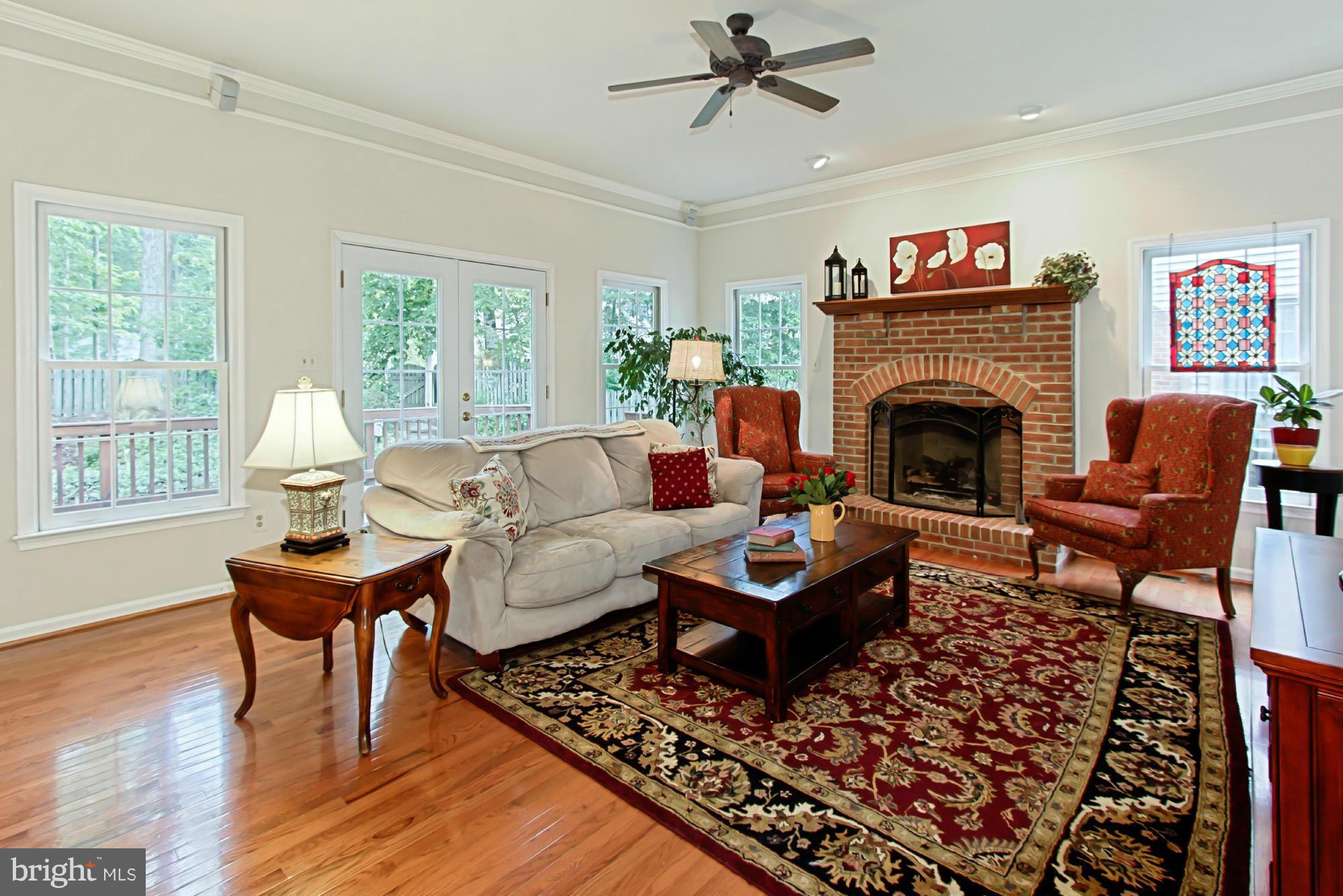 8127 Ridge Creek Way Springfield, VA 22153 - Photo 15 of 30 a living room with furniture and a fireplace