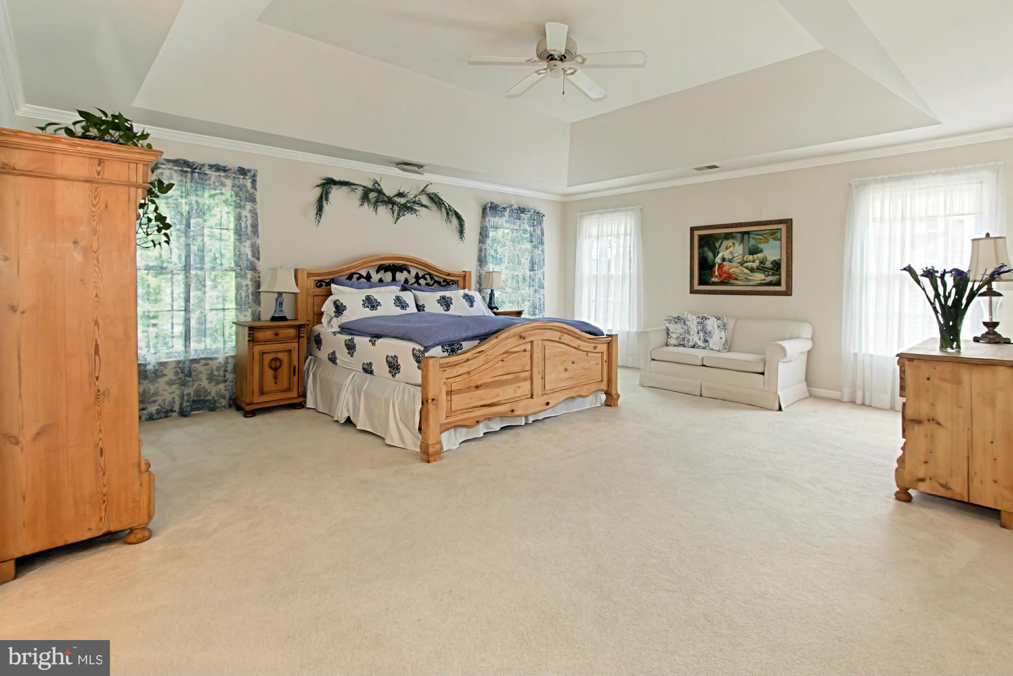 8127 Ridge Creek Way Springfield, VA 22153 - Photo 17 of 30 a bedroom with a bed and a couch