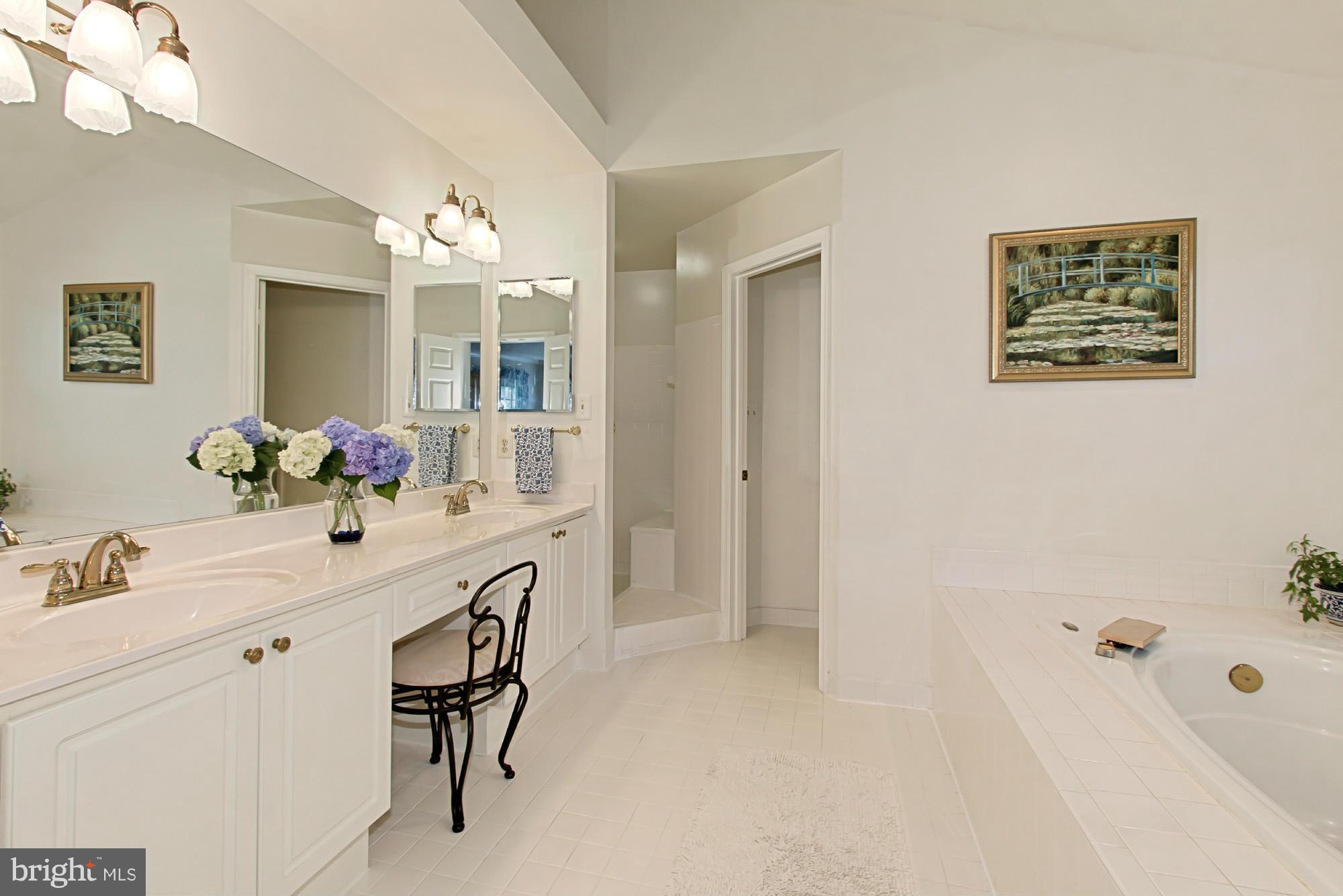 8127 Ridge Creek Way Springfield, VA 22153 - Photo 18 of 30 a bathroom with a sink double vanity granite tub and a mirror