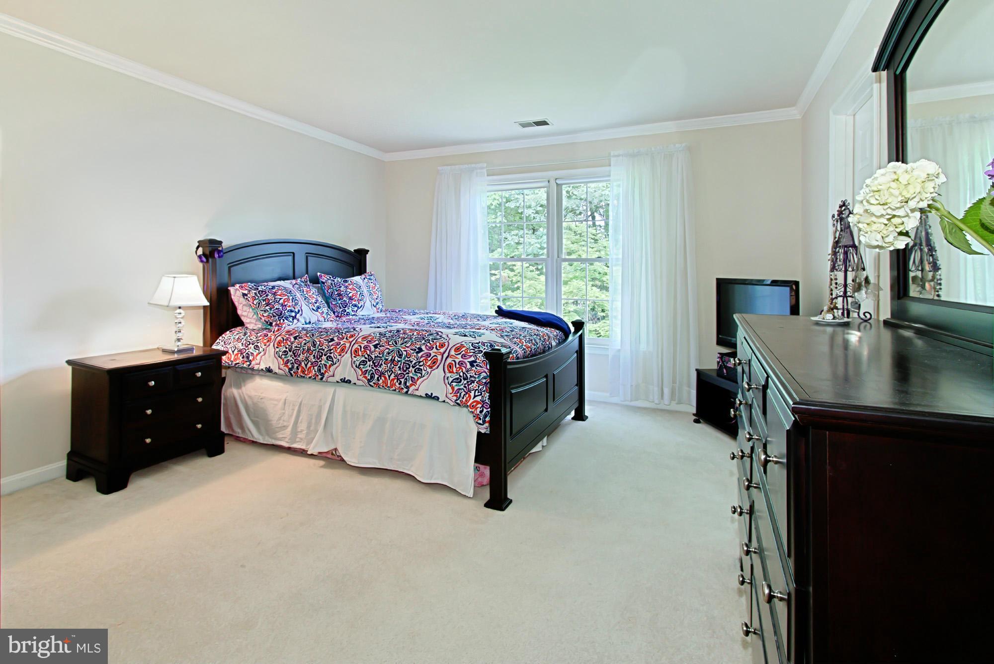 8127 Ridge Creek Way Springfield, VA 22153 - Photo 21 of 30 a bed room with a bed and a dresser