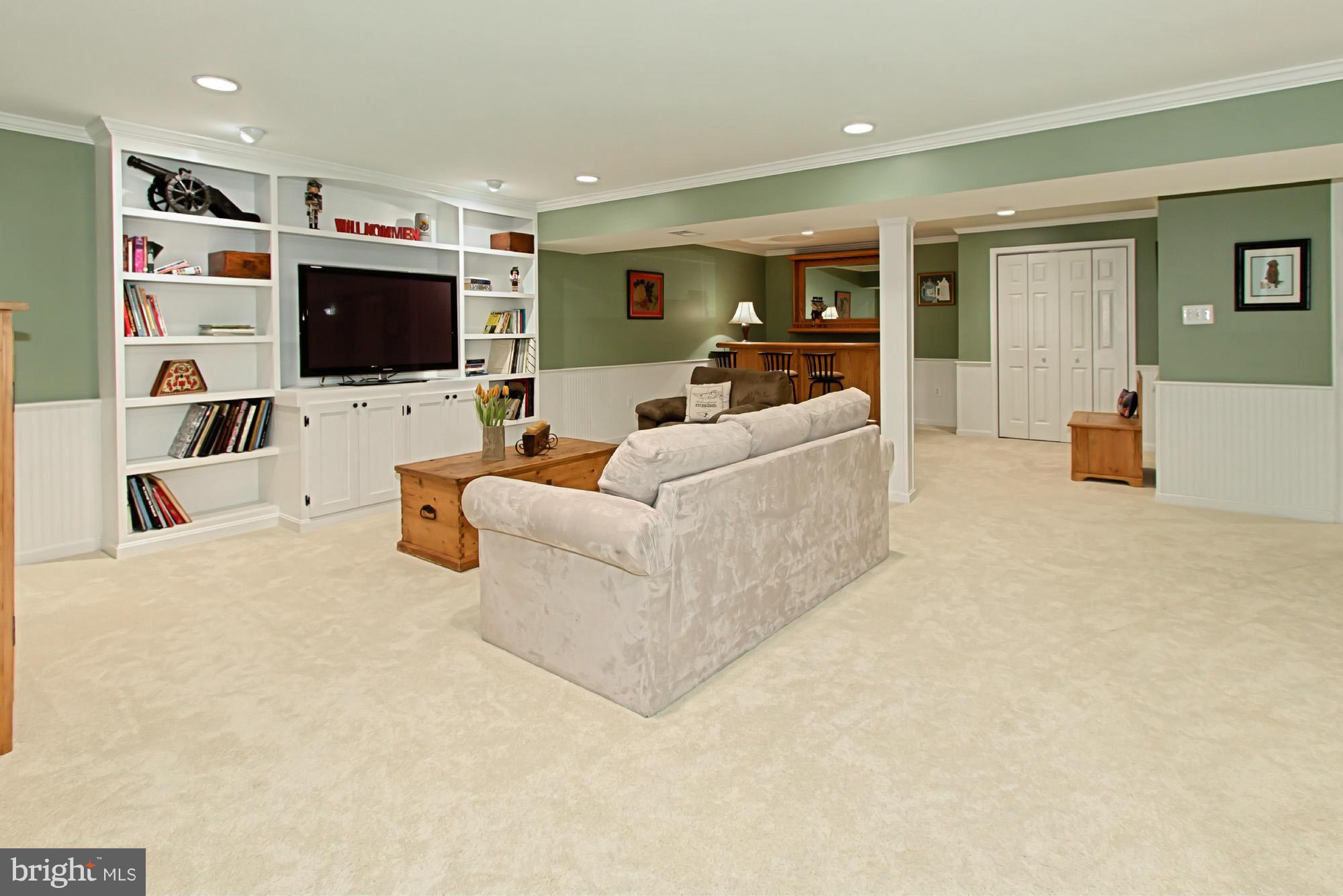 8127 Ridge Creek Way Springfield, VA 22153 - Photo 24 of 30 a living room with furniture and a flat screen tv