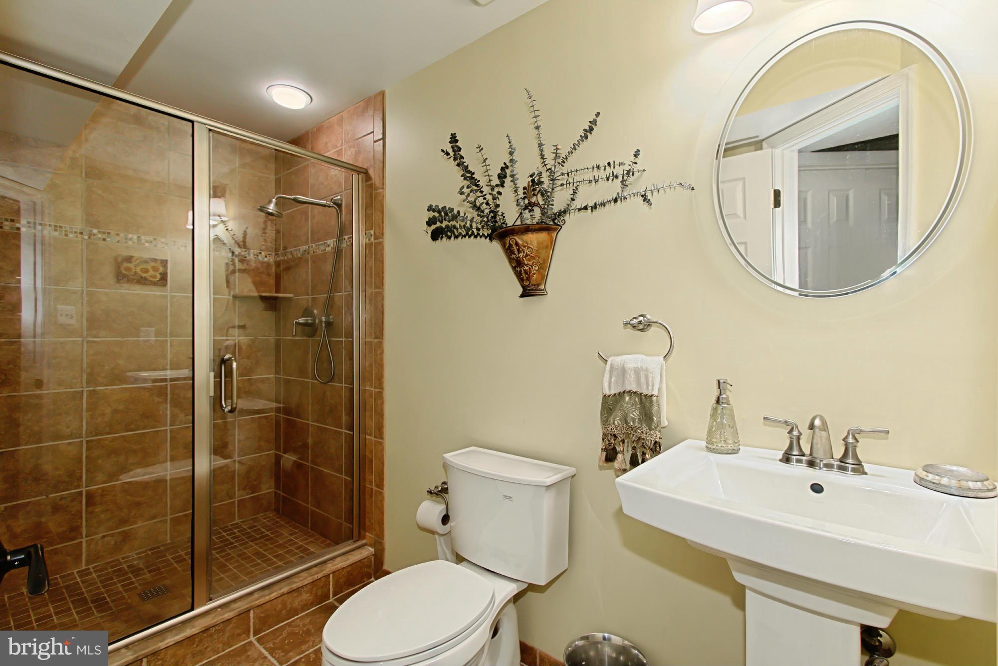 8127 Ridge Creek Way Springfield, VA 22153 - Photo 26 of 30 a bathroom with a sink a toilet and shower